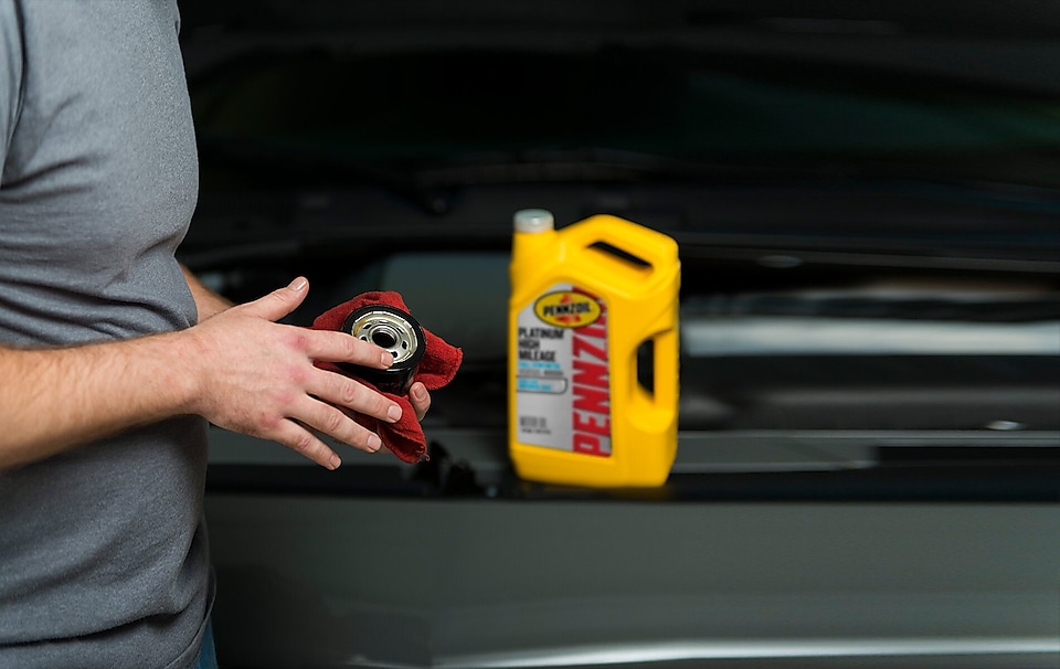 Pennzoil Oil person cleaning oil filter
