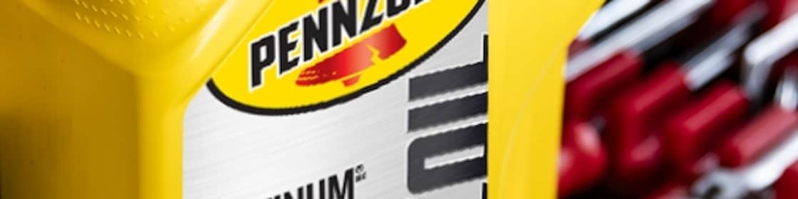 Two cans of motor oil in auto body shop