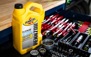 Two cans of motor oil in auto body shop