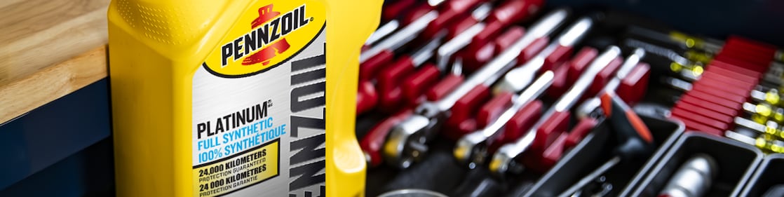 Two cans of motor oil in auto body shop