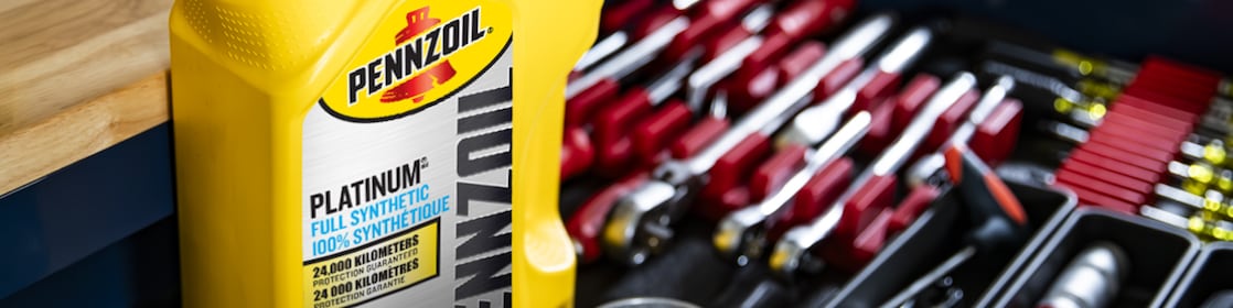 Two cans of motor oil in auto body shop