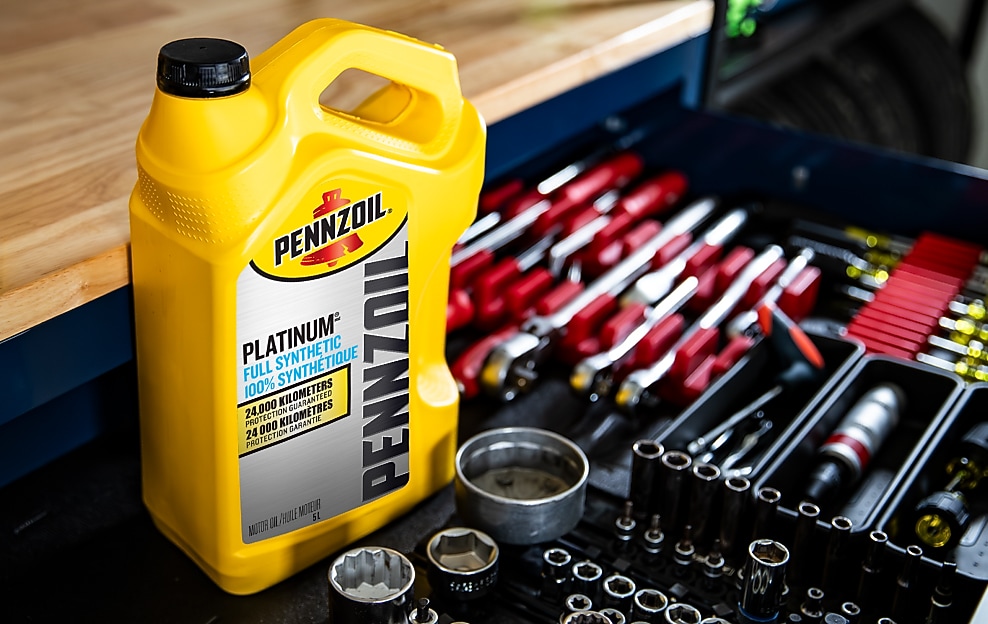 Two cans of motor oil in auto body shop