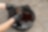 Man holds a filter and oil bucket is on the floor