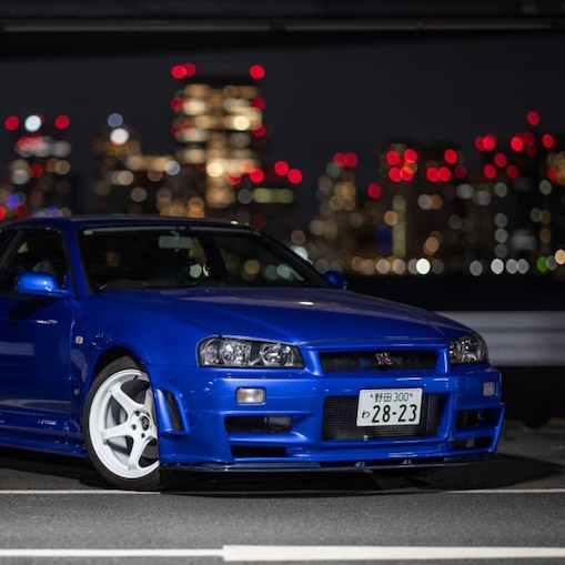 Larry Chen's restored R34 GT-R under city lights.