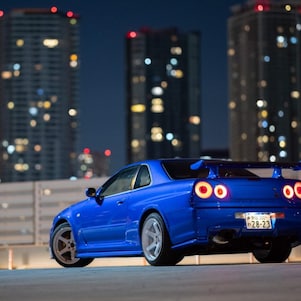 Larry Chen's restored R34 GT-R under city lights.