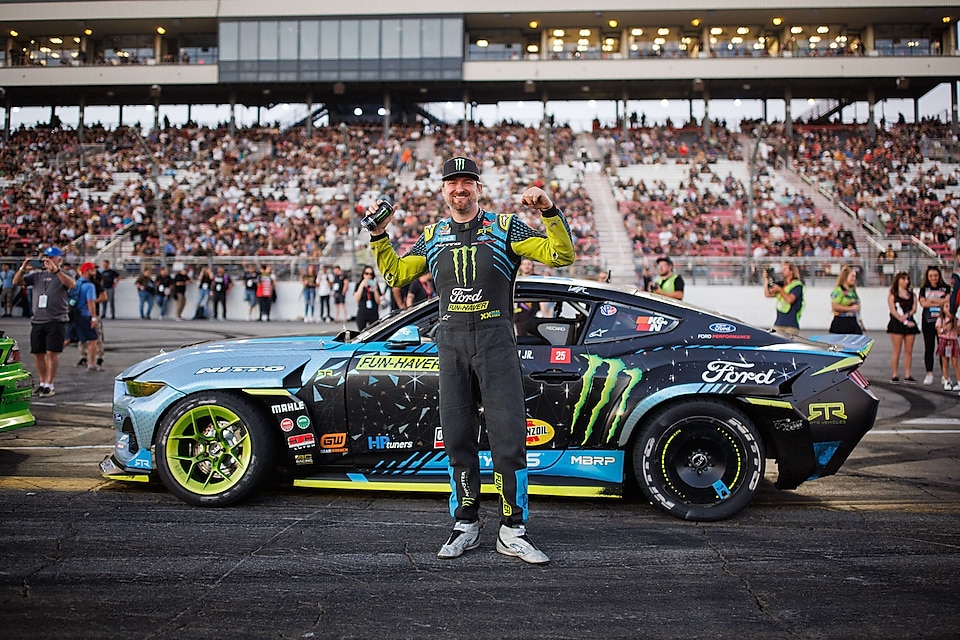 Man standing in front of racecar