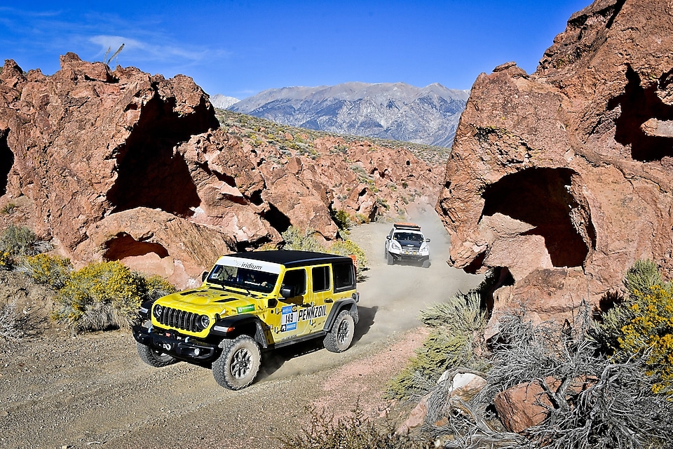 Jeep driving on dirt trail in desert