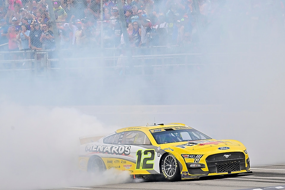 Yellow racecar in smoke