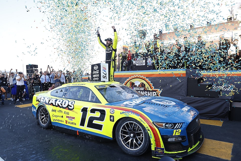 A race car with a crowd of people in the background