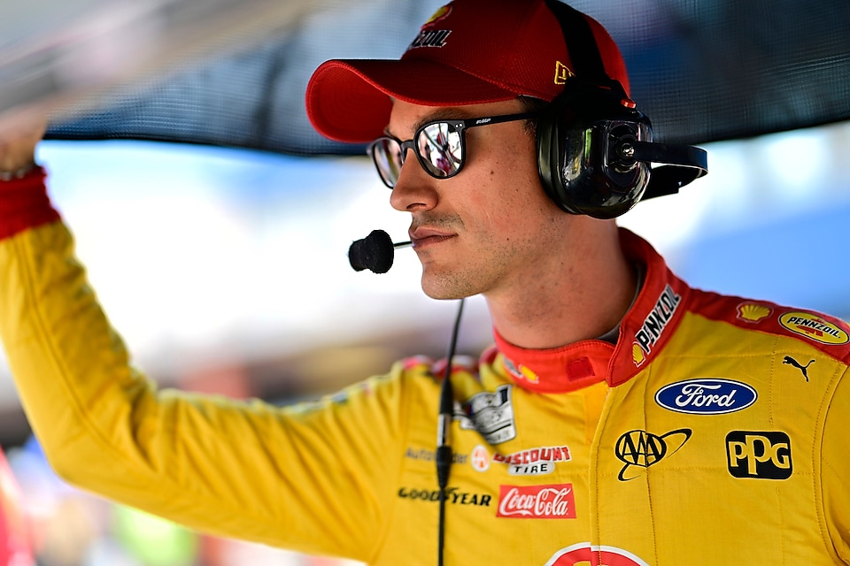 Man in racesuit with headset