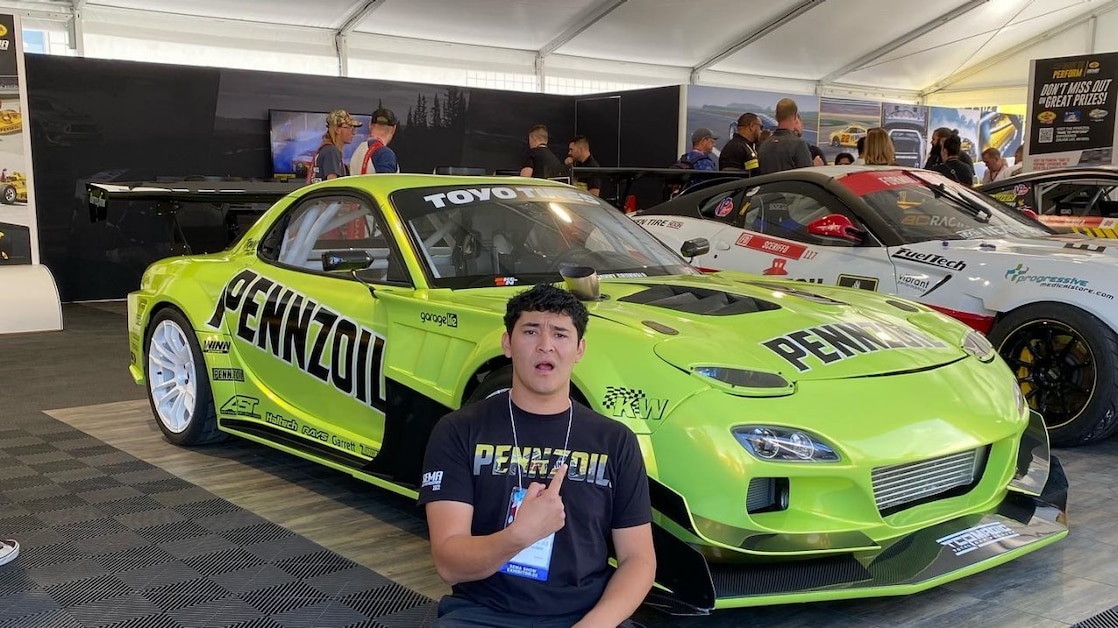 Estevan with Jonny Grunwald’s Mazda RX7 at SEMA 2022