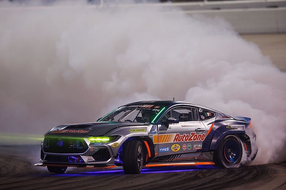 A race car on a track with smoke