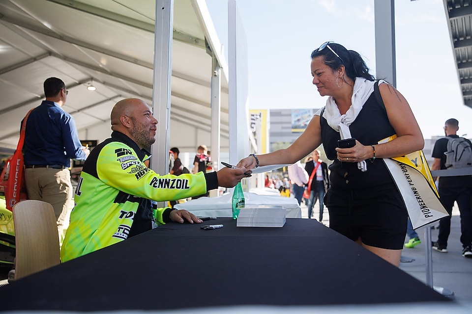 A person handing a person a card to a person