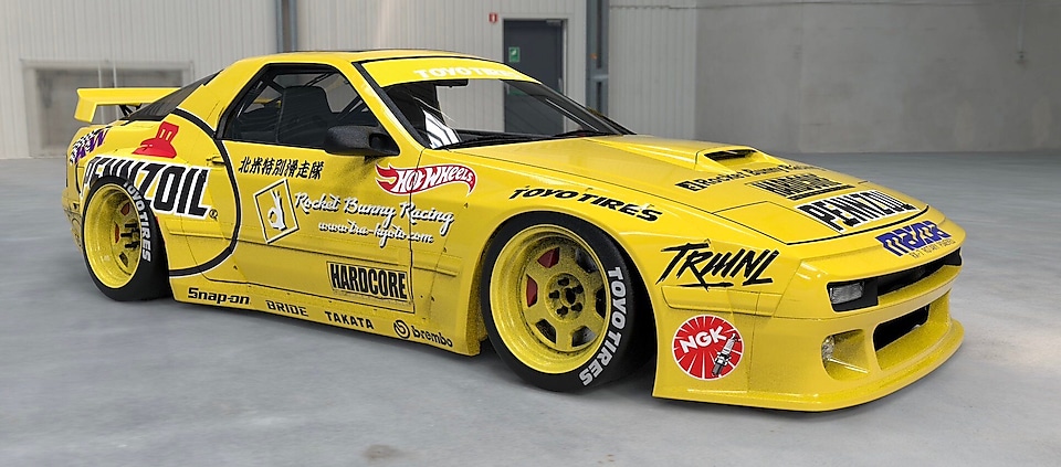 A yellow race car with stickers on the side