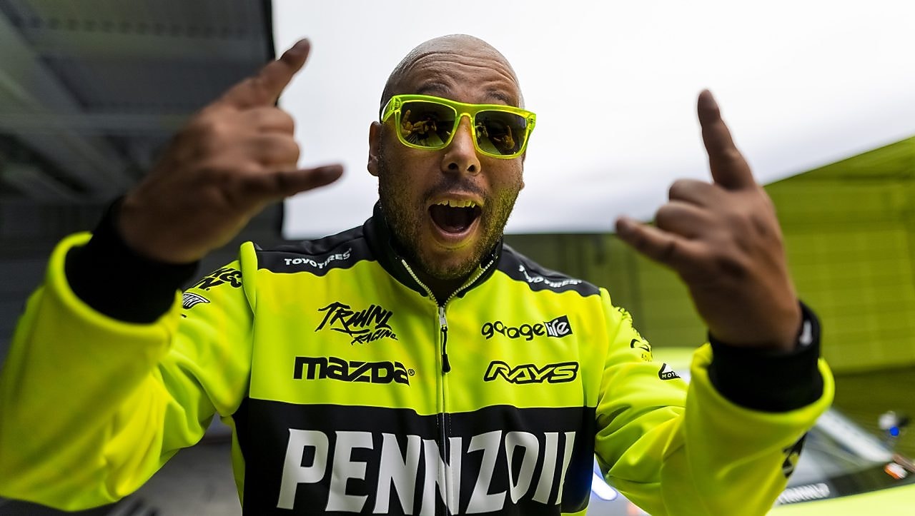 A person wearing sunglasses and green jacket