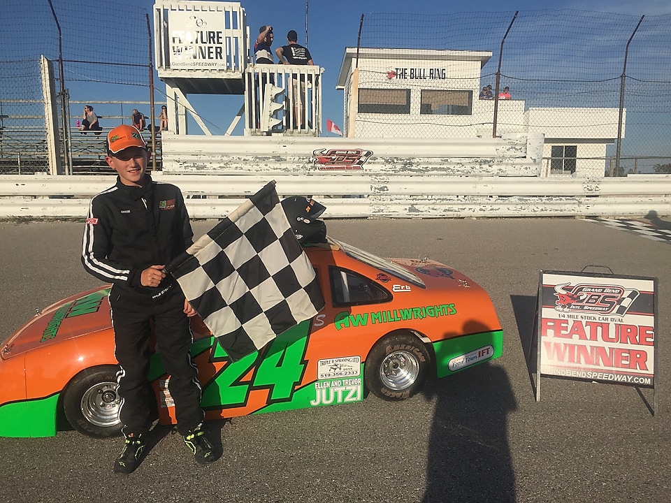 A person standing next to a race car