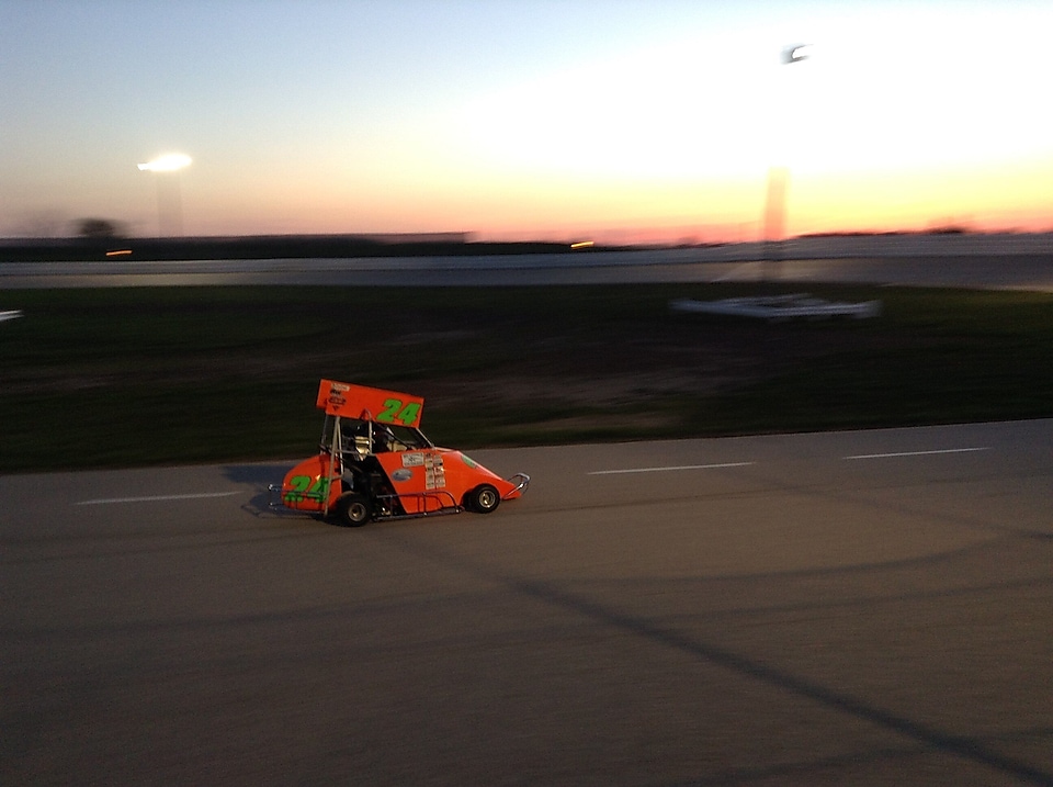 An orange vehicle on a road