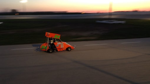 An orange vehicle on a road
