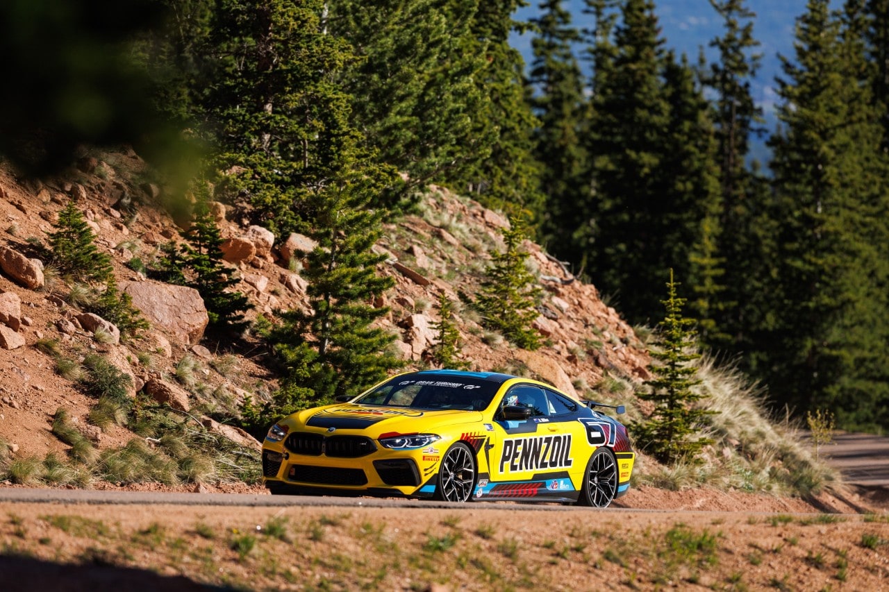 A yellow race car on a dirt road