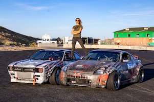 A person standing on top of two cars 