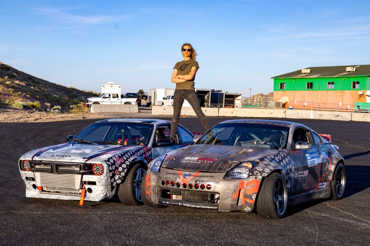 A person standing on top of two cars 