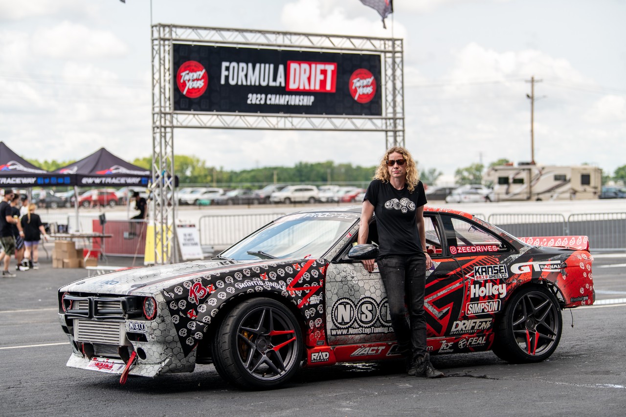 A person standing next to a car