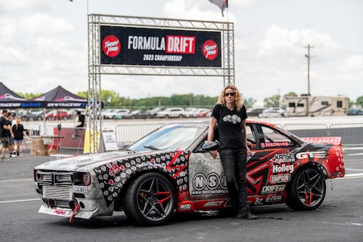 A person standing next to a car