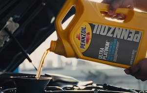 oil pouring into motor