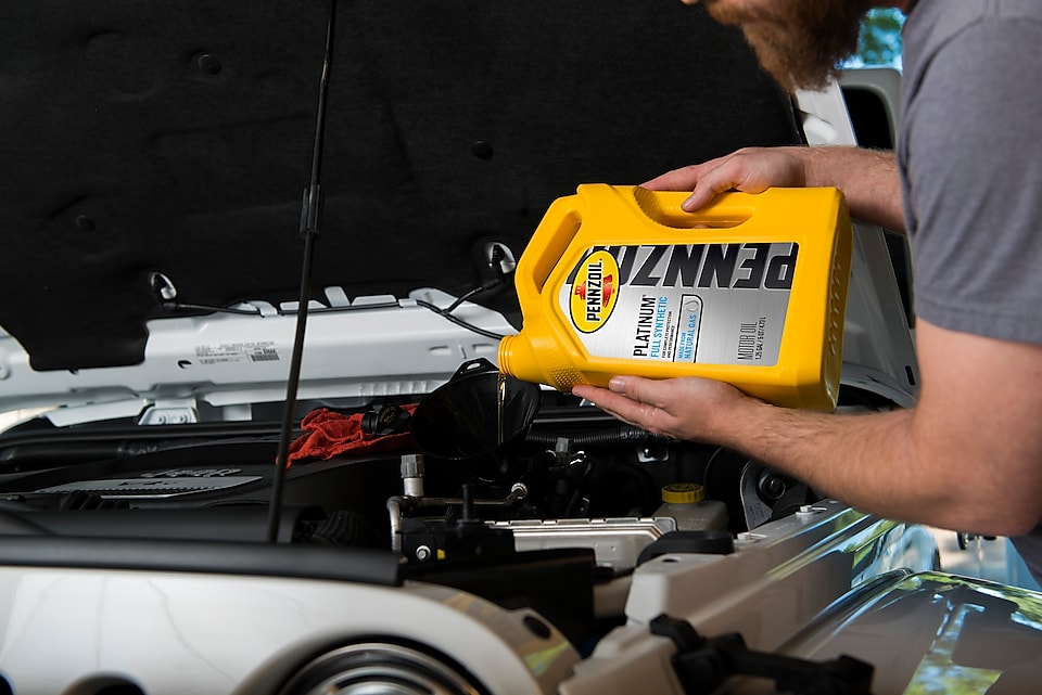 Pennzoil Full Synthetic Oil being put into car motor