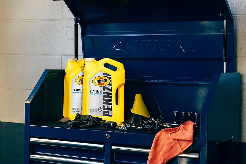 Two cans of motor oil in auto body shop