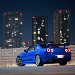 Larry Chen's restored R34 GT-R under city lights.