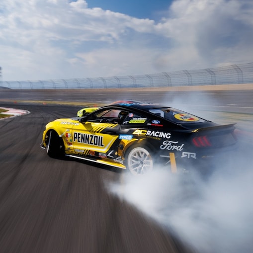 Pennzoil in action, leaving a trail of smoke on the track, captured by Larry Chen.