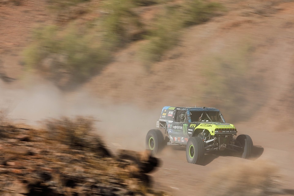 Car on a dirt trail in desert