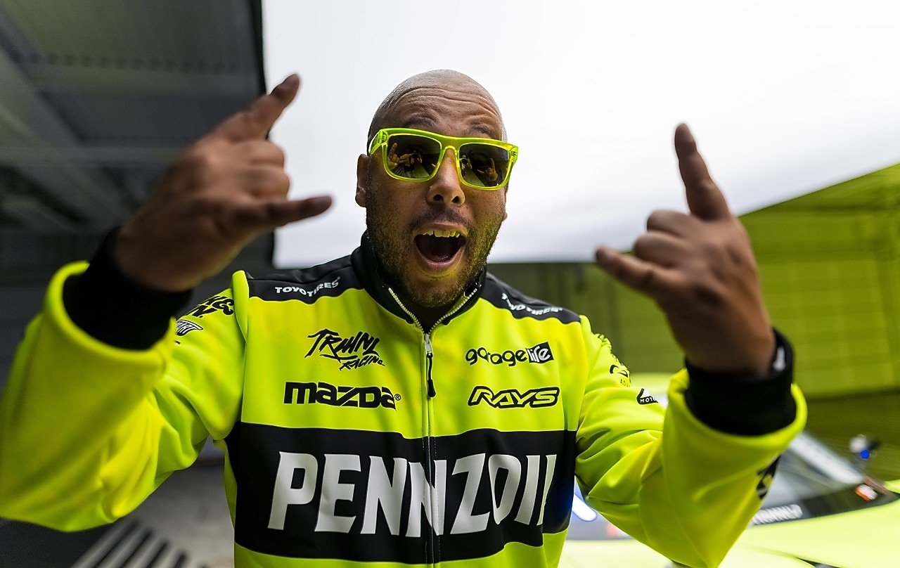 A person wearing sunglasses and green jacket