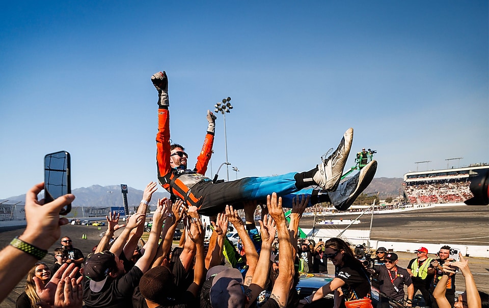 James Deane celebrates with his team after clinching the 2024 Formula DRIFT PRO Championship at Irwindale Speedway.