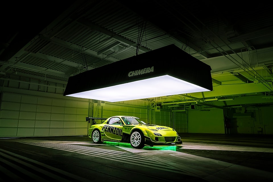 A car parked under a lit up ceiling