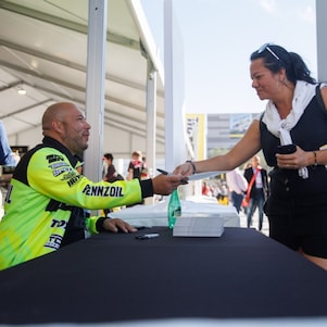 A person handing a person a card to a person