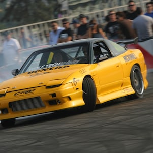 A yellow race car on a track