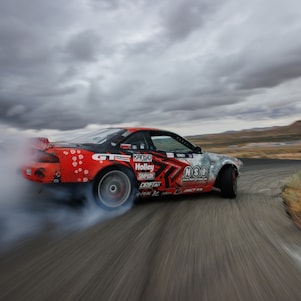 A car on a road with smoke coming out of the front