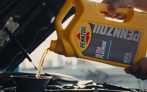 oil pouring into motor