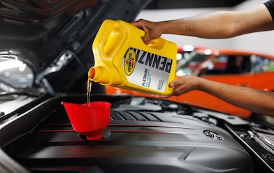 Pennzoil oil being pour in engine