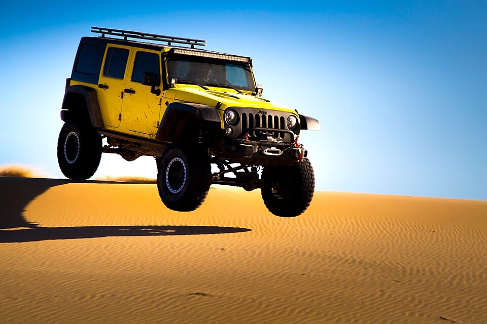 voiture sautant dans une dune du désert